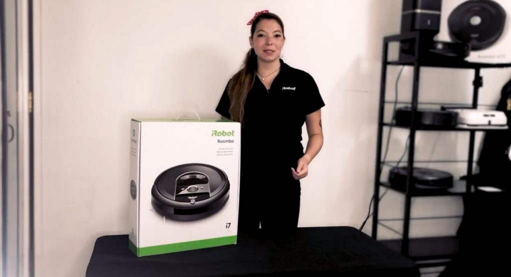 woman explaining the features of an irobot vacuum cleaner