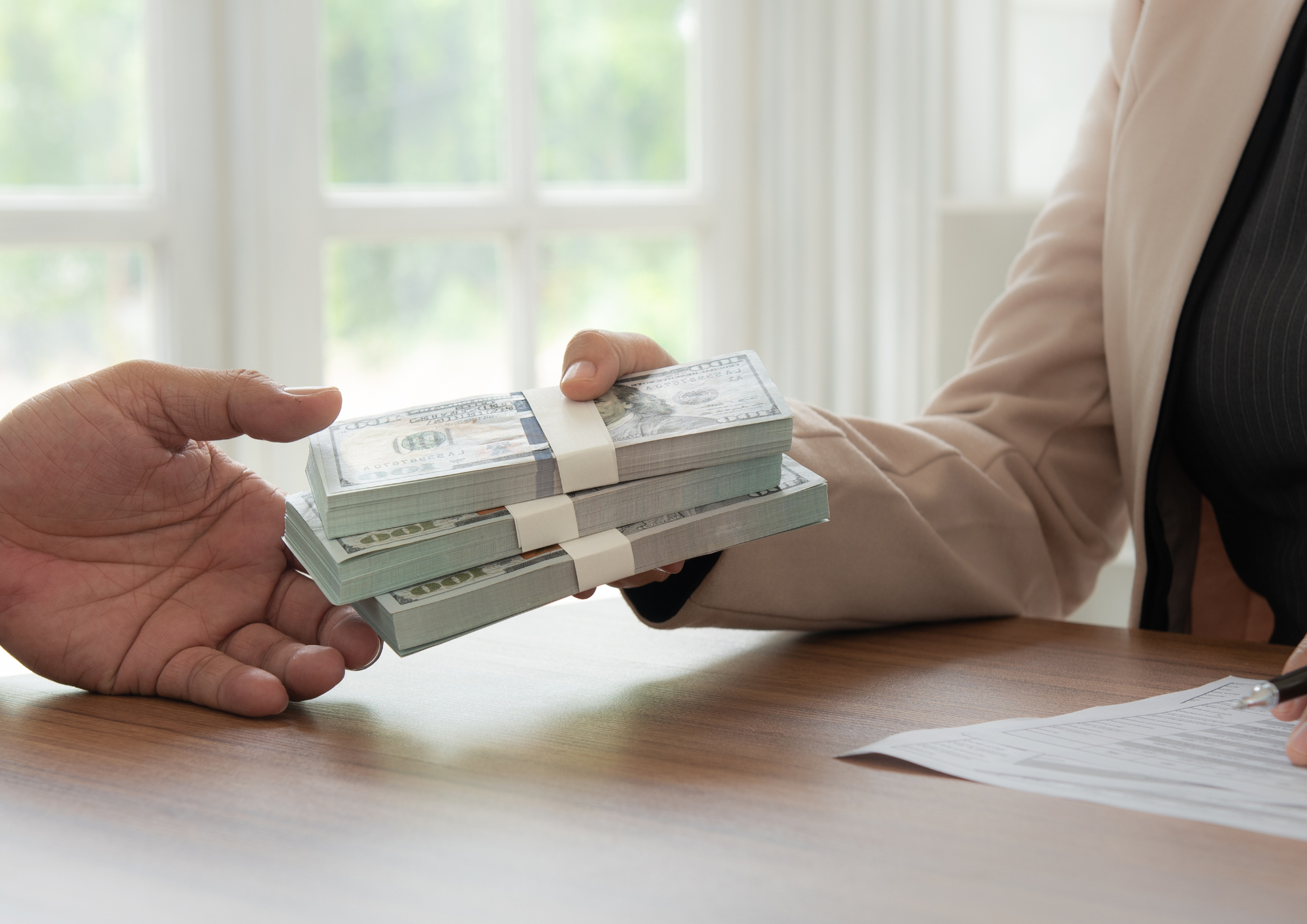 Man handing over wad of cash