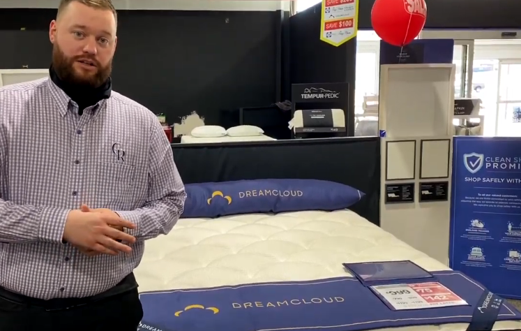 sales man in front of dreamcloud display area