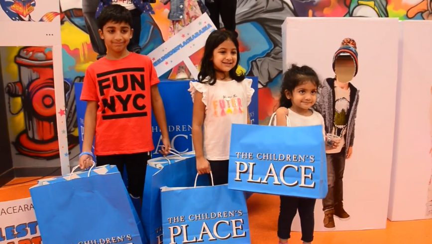kids carrying the children's place shopping bags