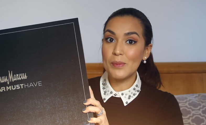 woman holding a Neiman Marcus box