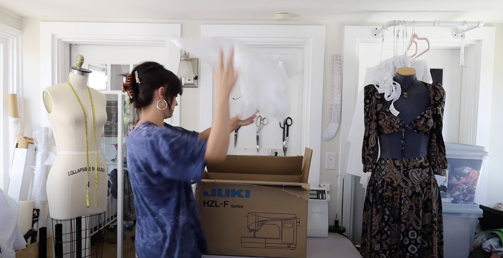 woman in sewing room with mannequins