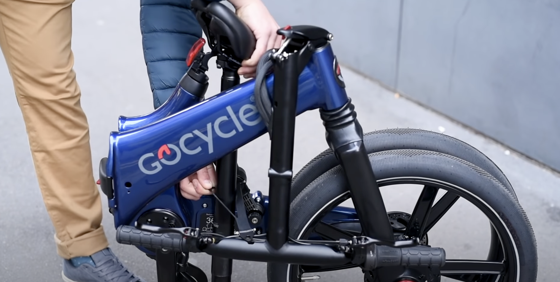 man assembling blue GoCycle...