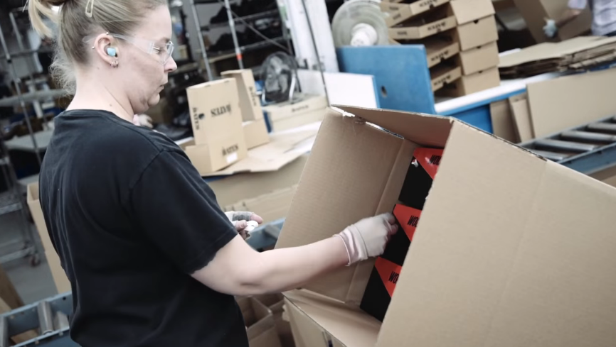 woman packing a box in manufacture