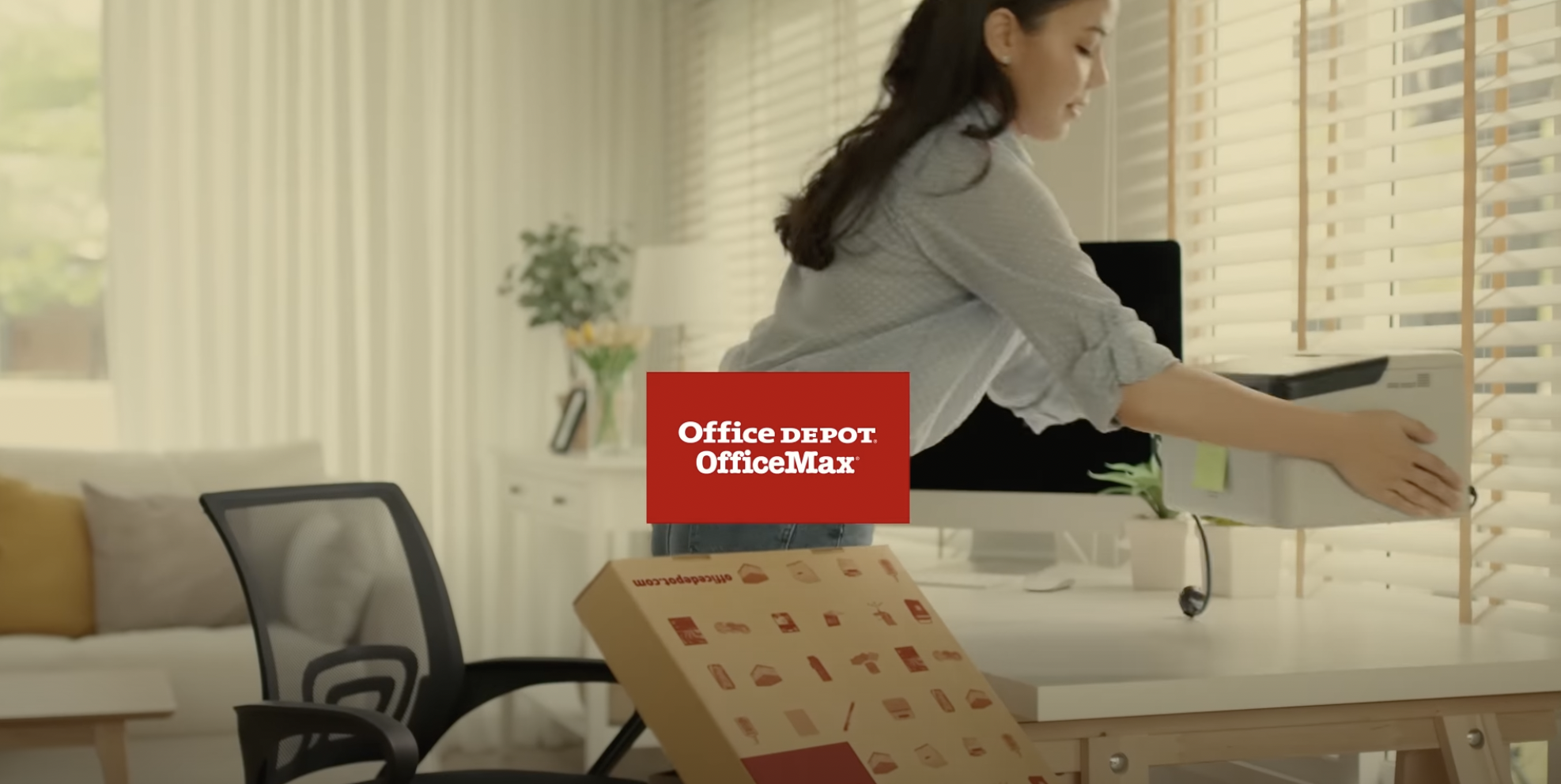 Woman in office placing printer on desk