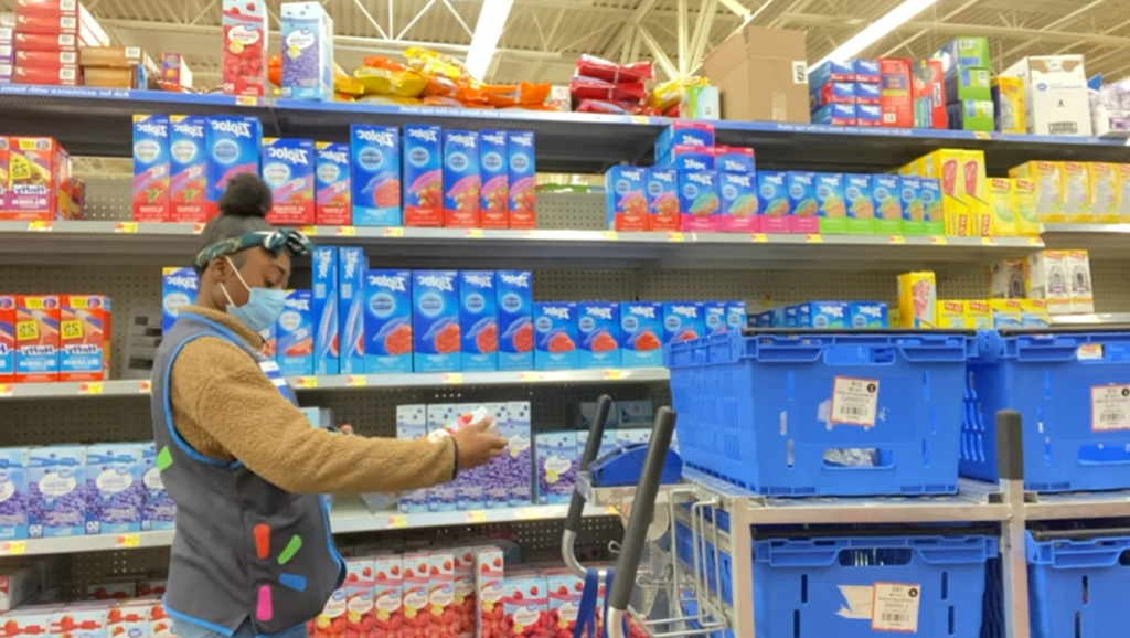 Young girl working as a stocker at walmart