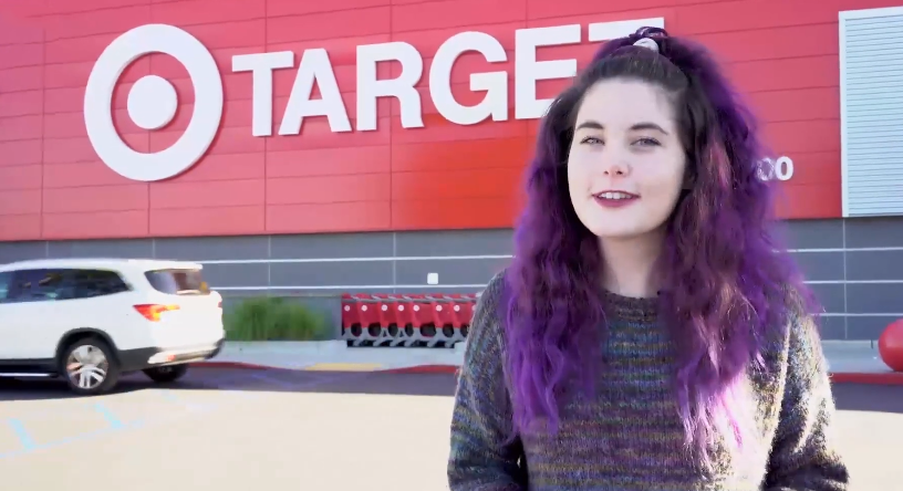 girl with purple hair in front of a target store
