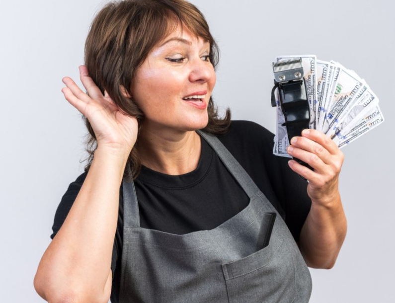 women wearing an apron holding a money fan 