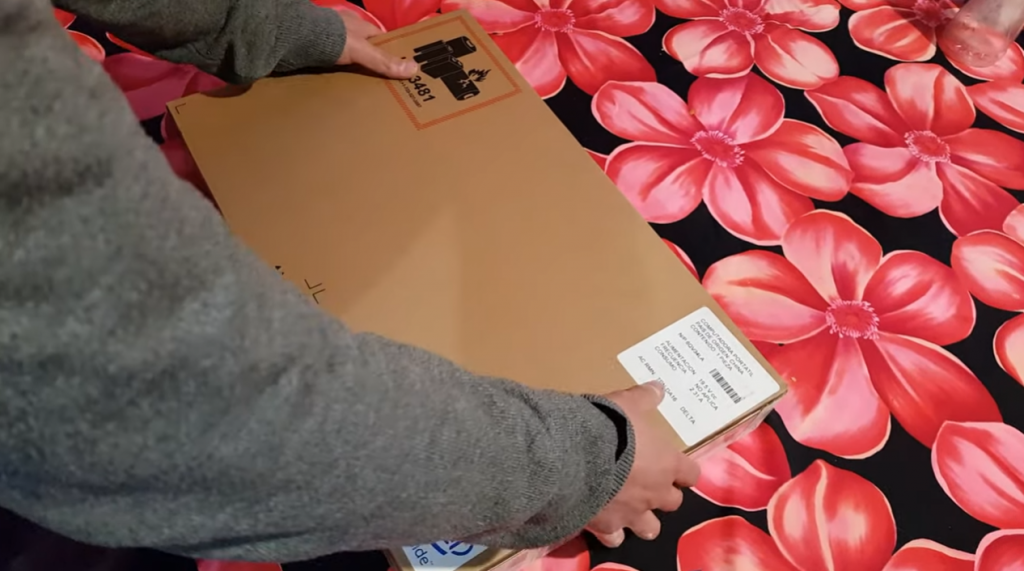 hands Unboxing an original hp product box