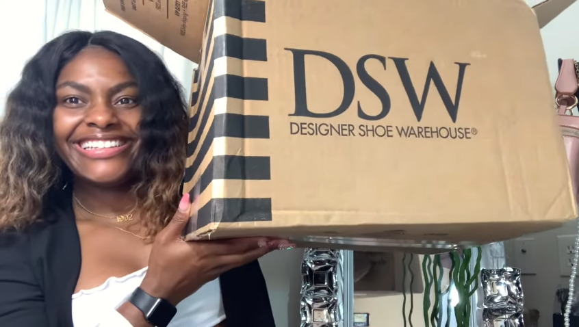 woman holding a DSW box