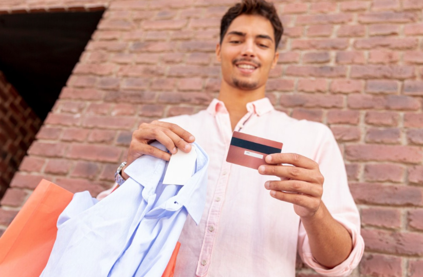 low angle smiling man looking at his card