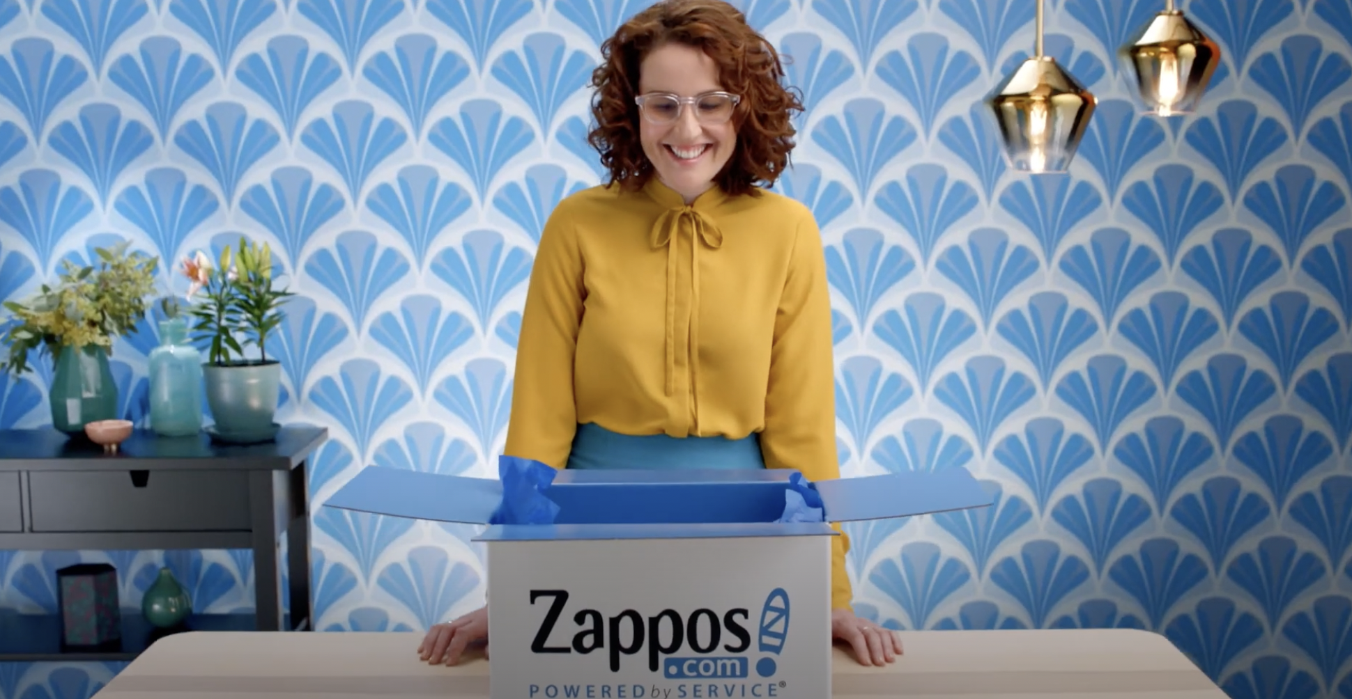 Girl with yellow blouse making zappos unboxing