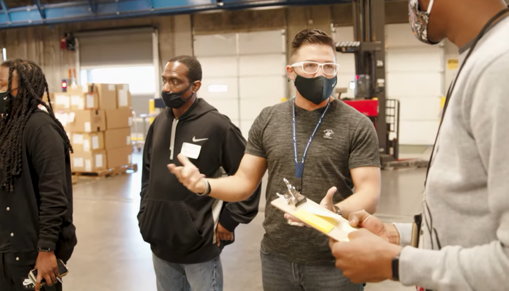 Nike workers in meeting at the warehouse