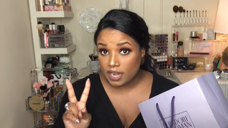 woman with a Bergdorf Goodman bag  in her makeup room