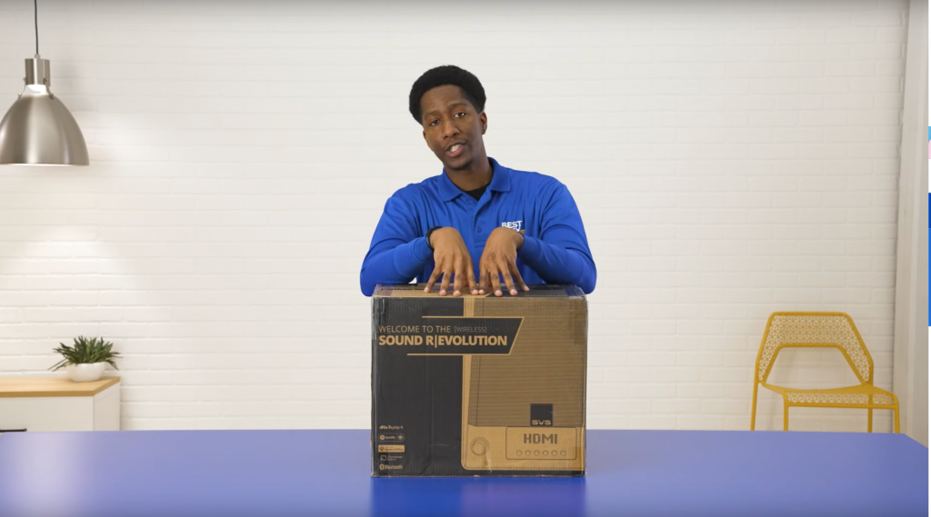 Best Buy male worker unboxing a speaker