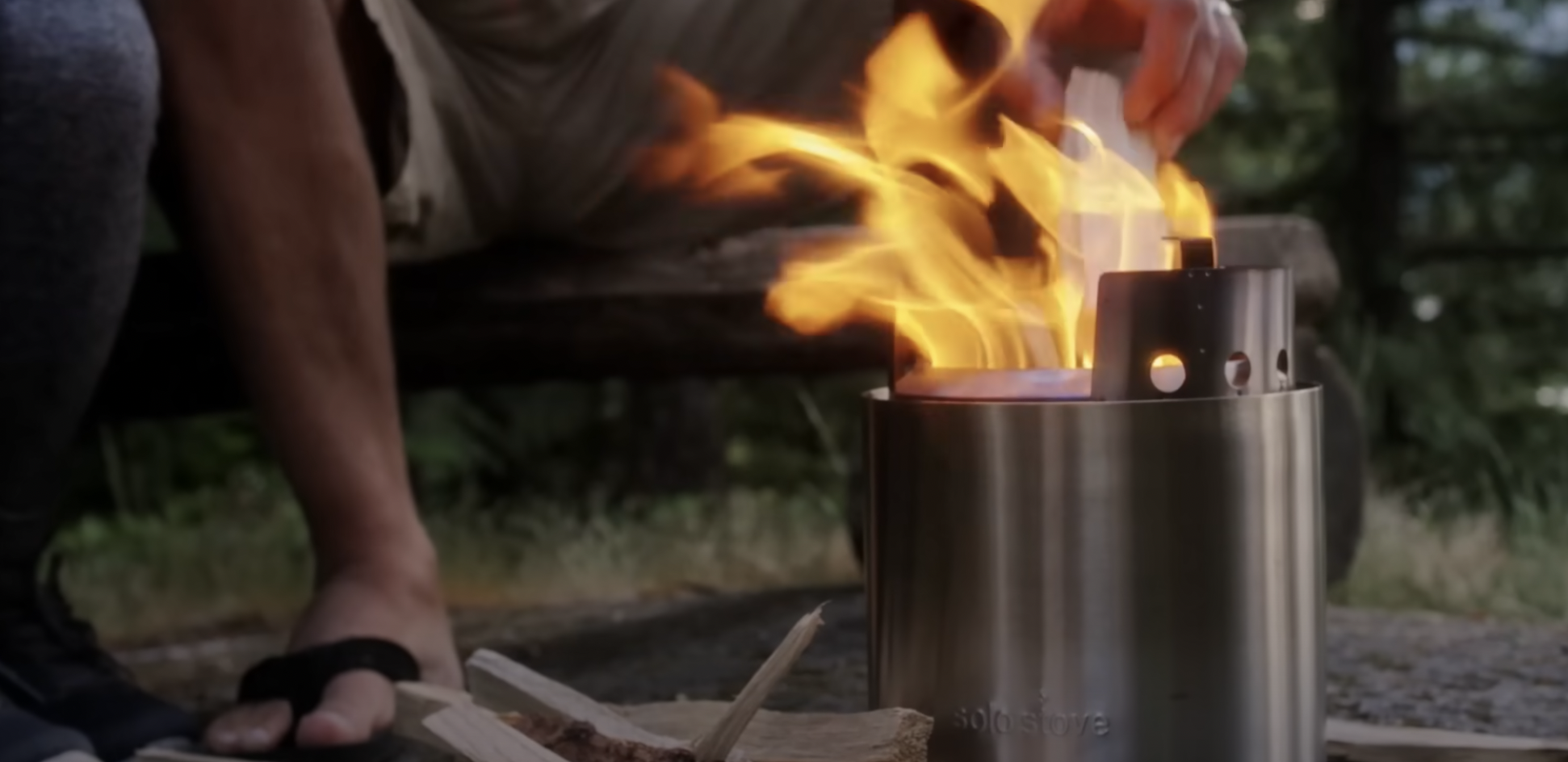 fire pit lit in the forest
