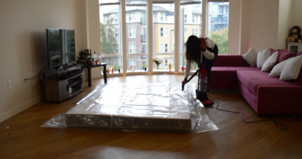 Woman sealing mattress with vacuum  to give back