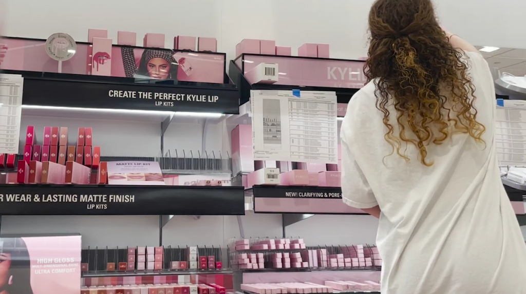 Woman arranging Ulta Beauty shelves