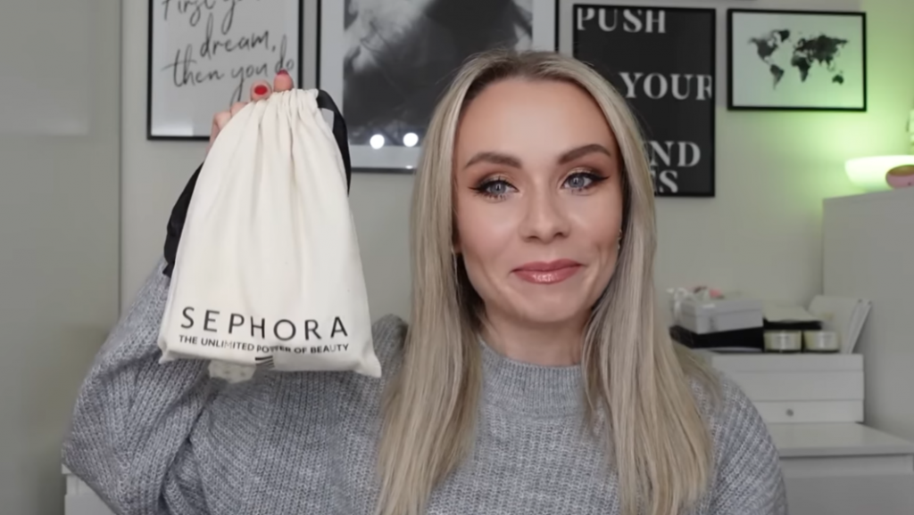 blonde woman holding a Sephora beauty bag