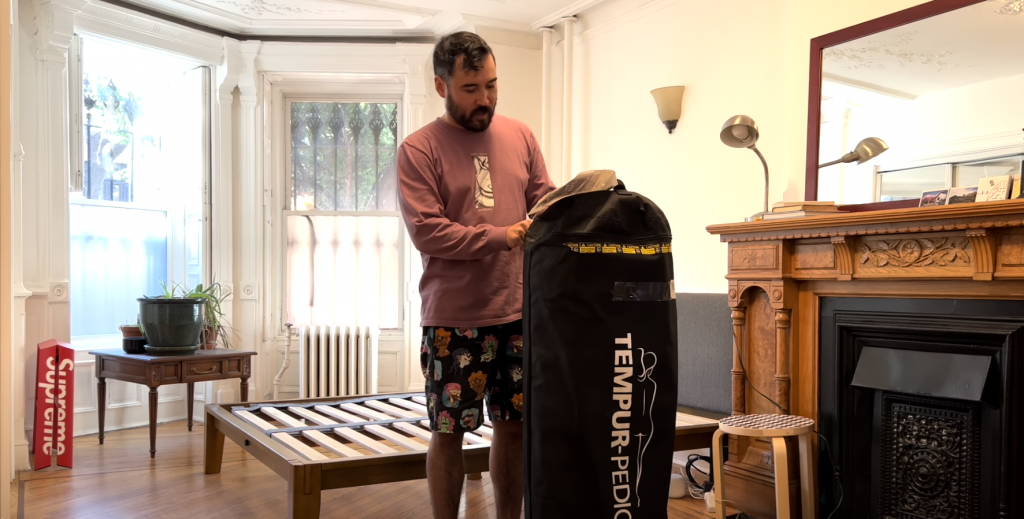 man opening tempur pedic mattress packaging