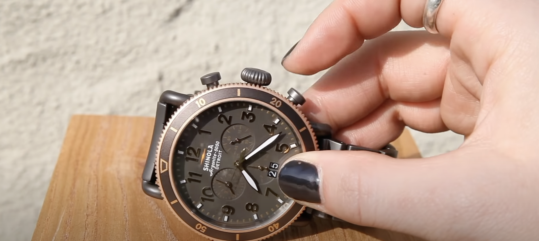 hand holding shinola watch