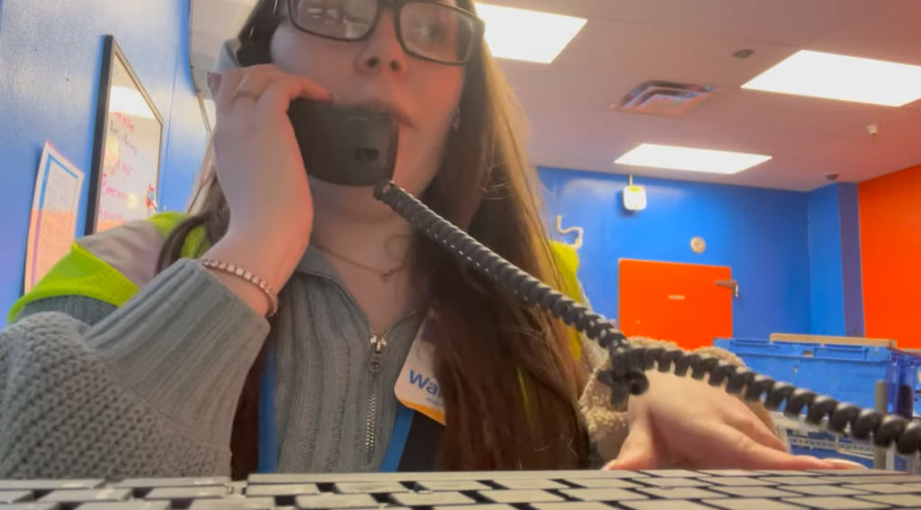 Walmart worker answering phone calls