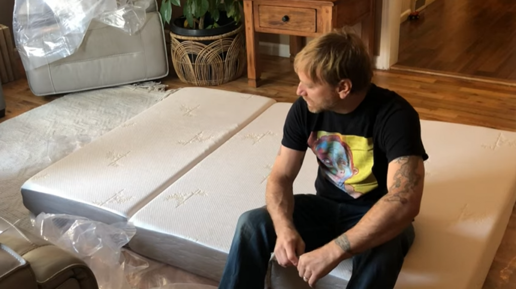 Man sitting on a new mattress