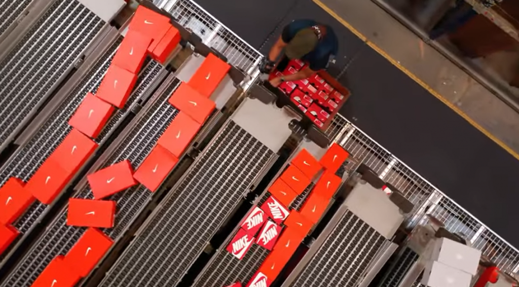 Nike worker in the warehouse packing boxes