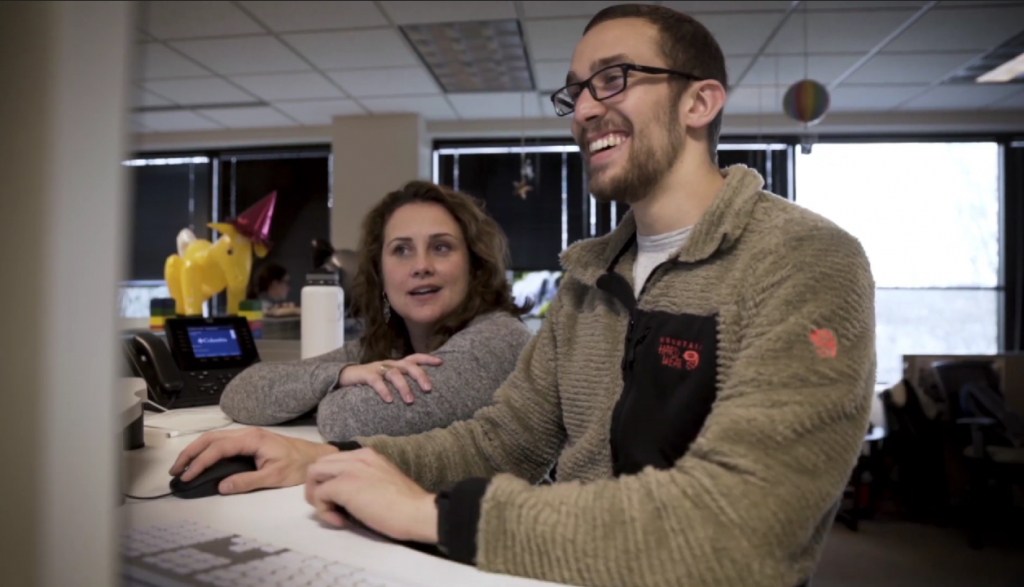 Customer services men and women looking at a computer