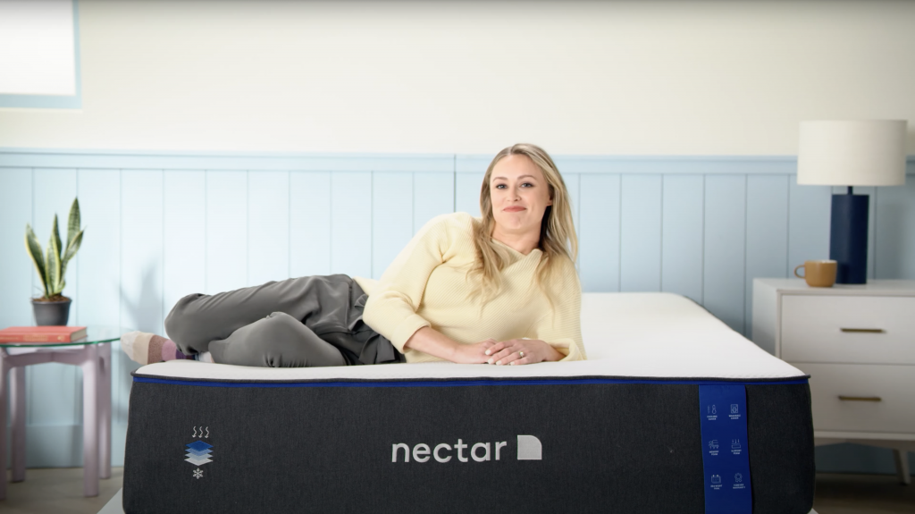 blonde woman laying down on a nectar mattress