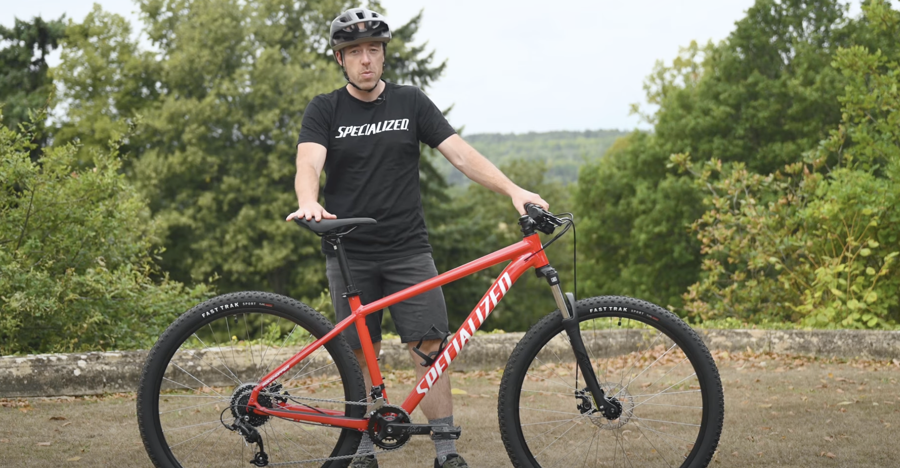 man holding red specialized...