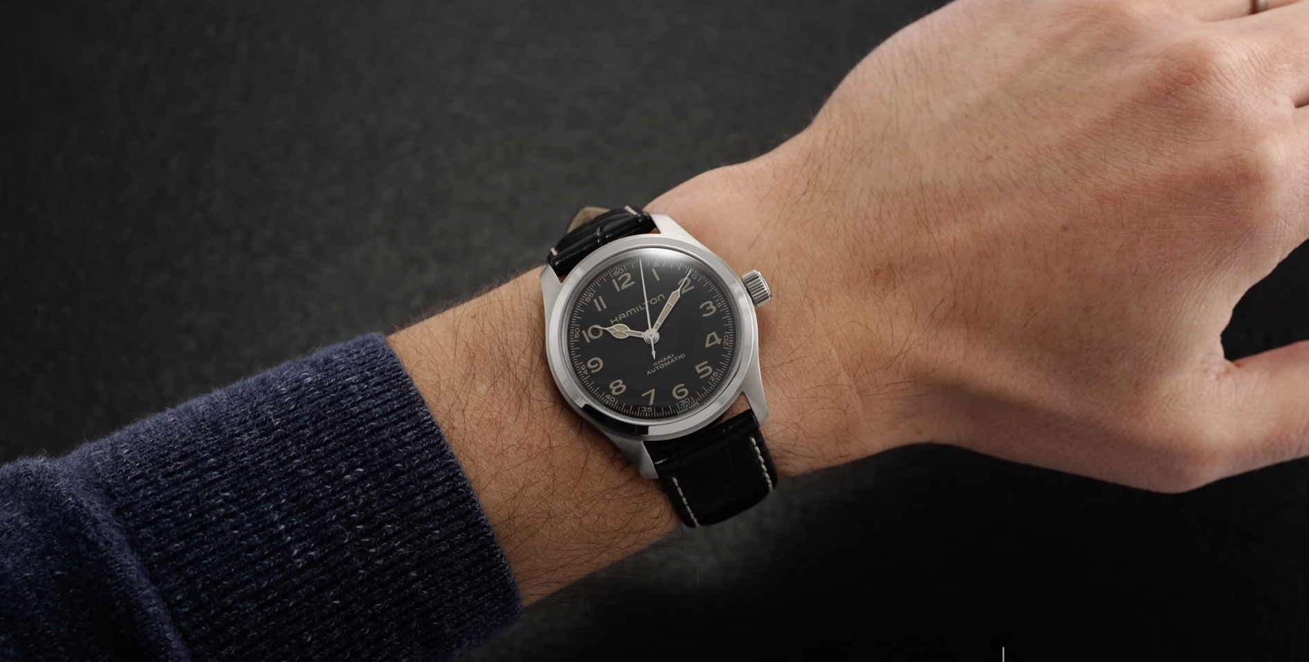 hand with black hamilton watch