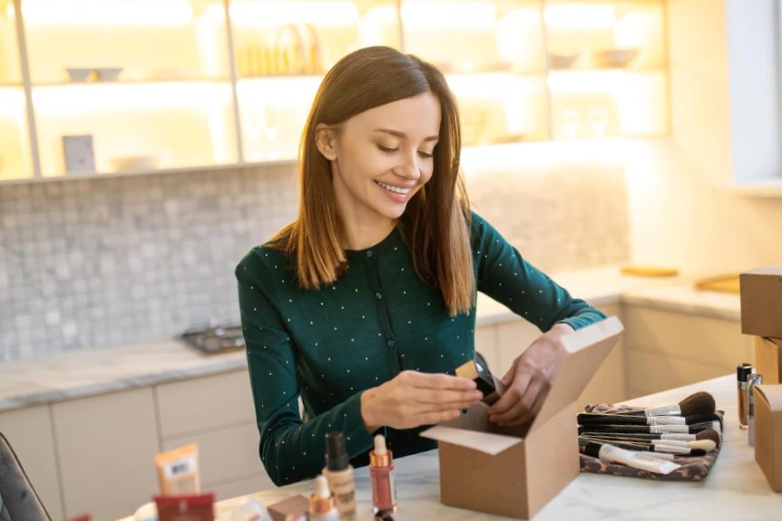 smiling young woman unpacking beauty products 