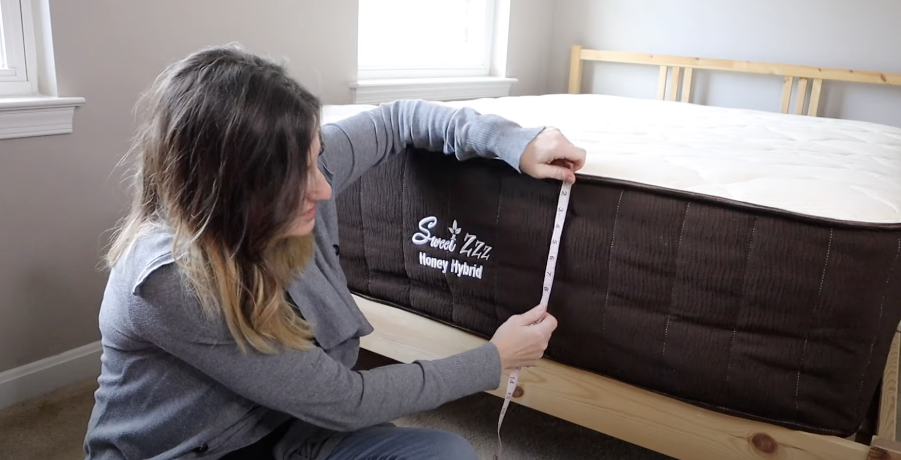 woman measuring mattress sw...