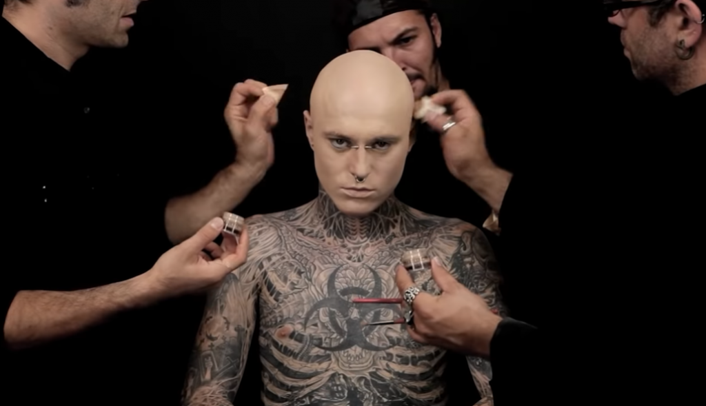 Tattooed bald man using dermablend products