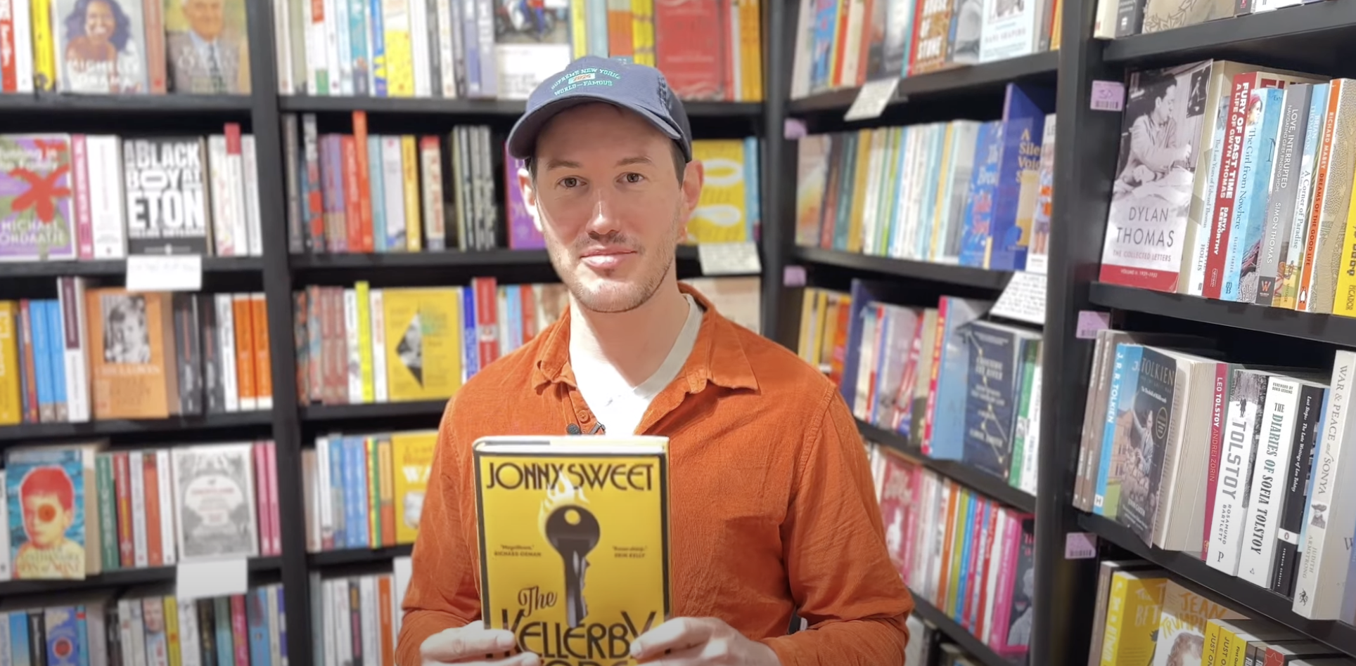 man holding book surrounded...