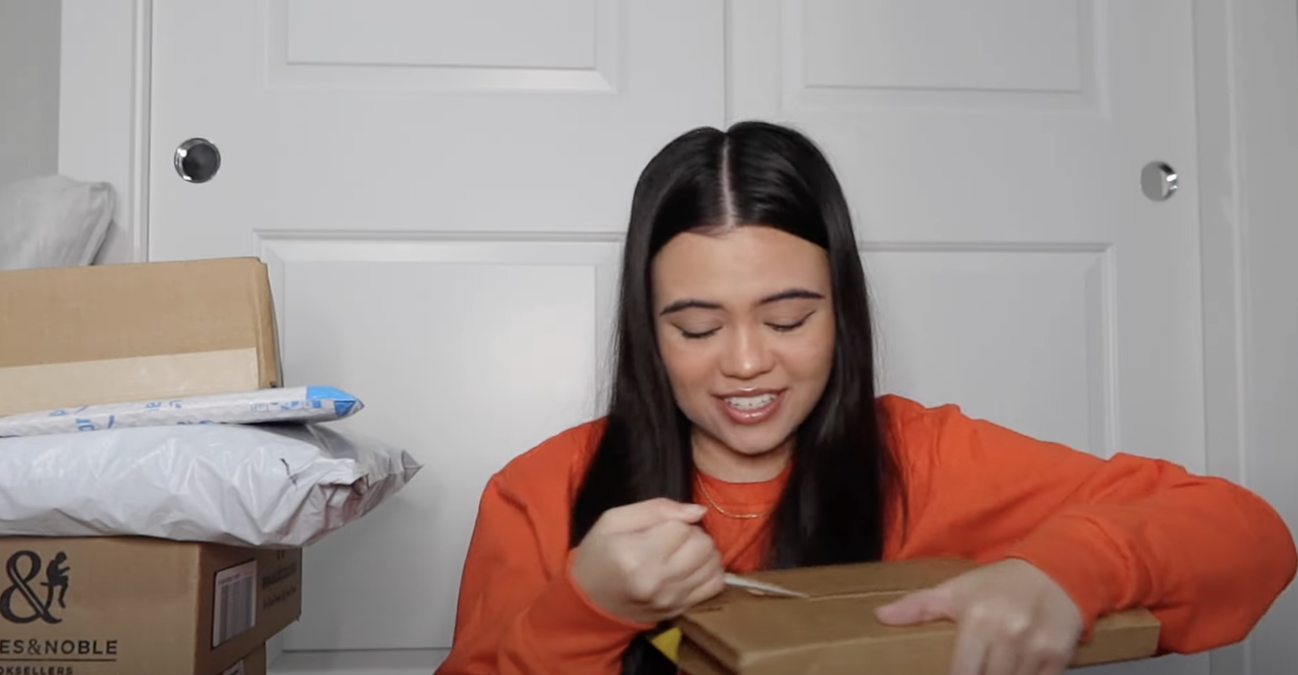 girl opening boxes of books...