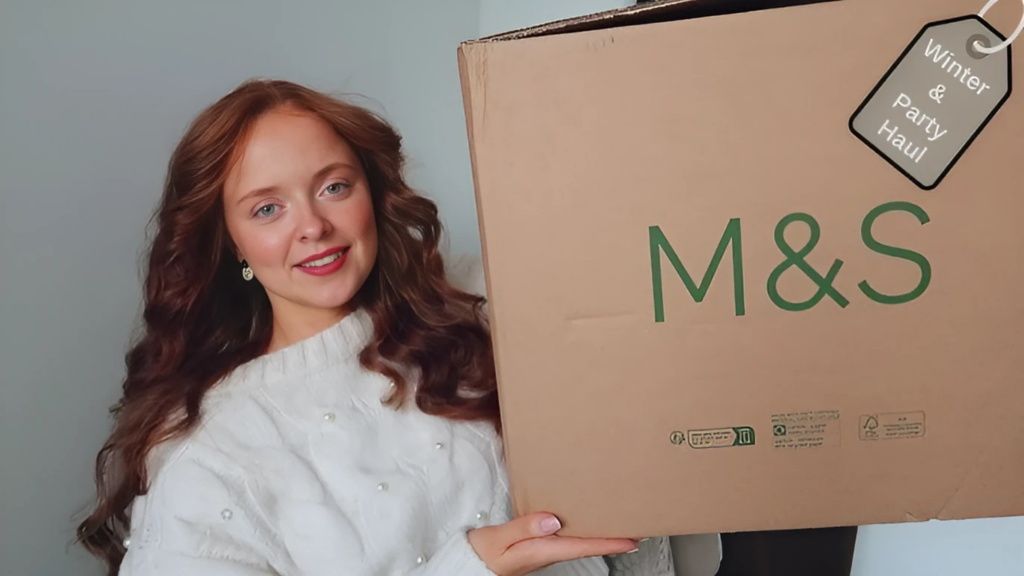 girl holding Mark and Spencer box