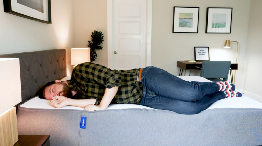 Man lying on a test mattress