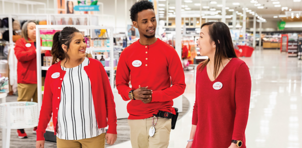 1 male and 2 females and target workers talking while walking inside of the store 
