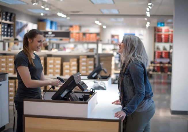 female cashier smiling at her customer