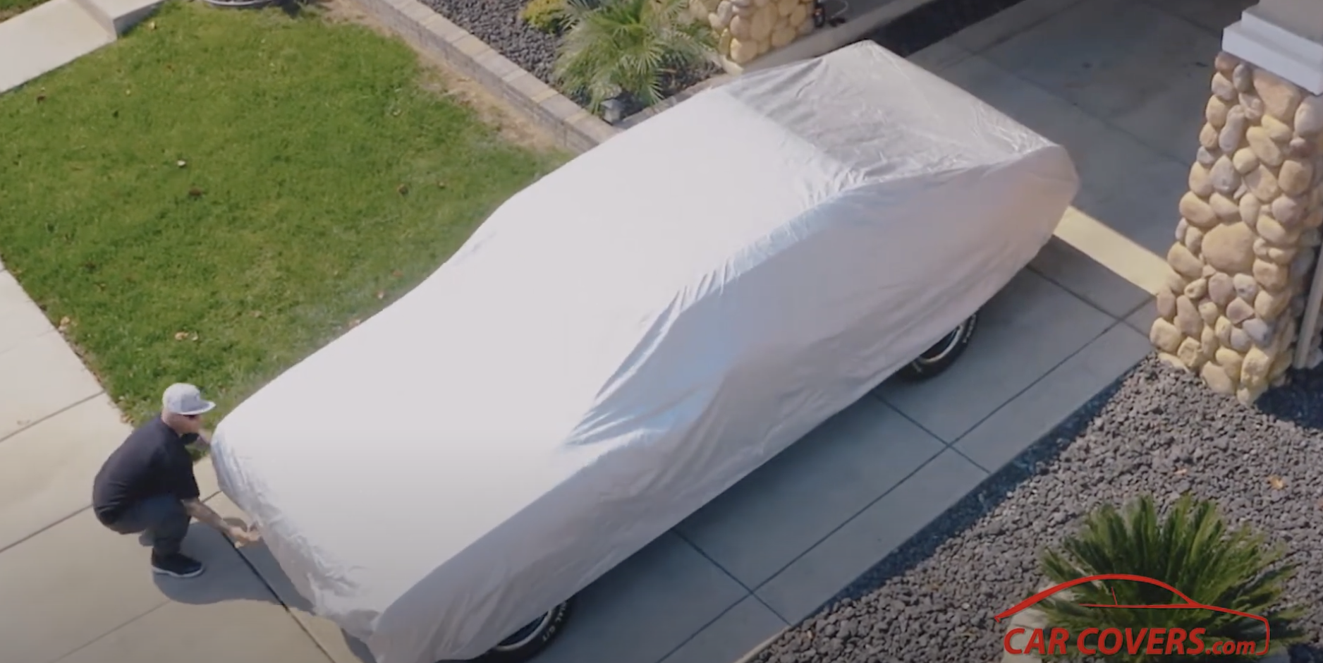 man putting up car cover