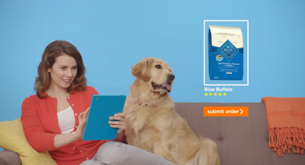 women sitting in a couch using a tablet next to a golden retriever dog 
