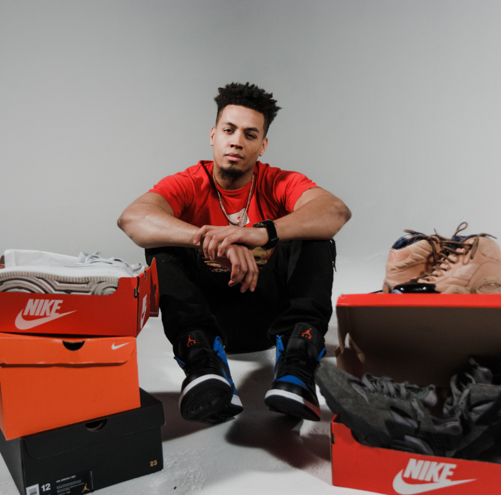 guy surrounded by nike shoes boxes