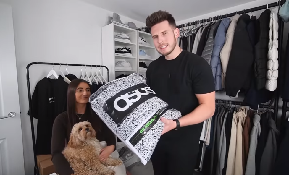 couple with dog showing a bag from ASOS store