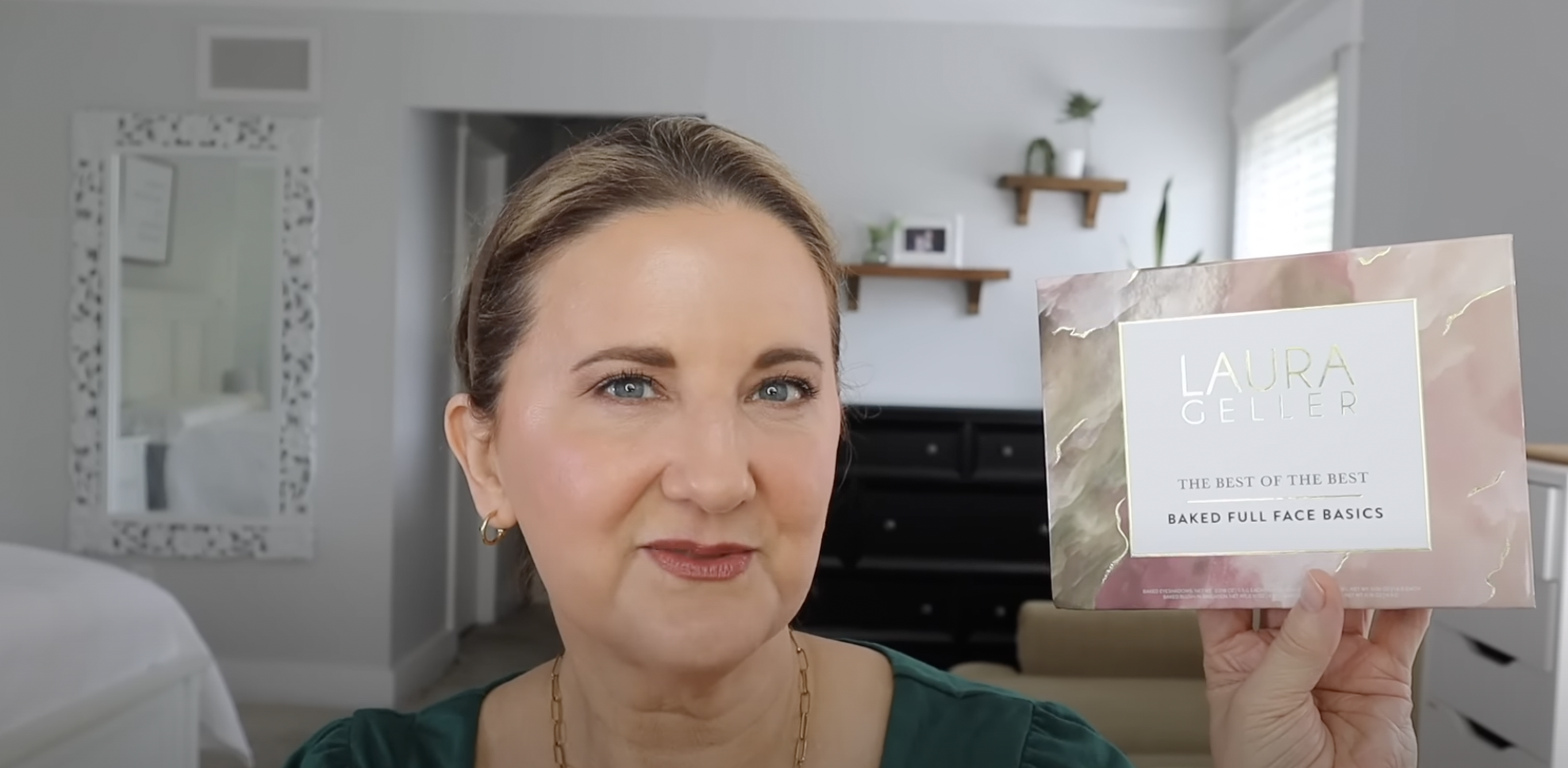 Woman showing laura geller product